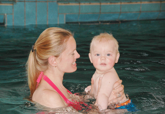 Ouder en kind zwemmen